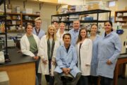 Thomas Spencer poses with the students in his lab, where they research reproductive and developmental biology.